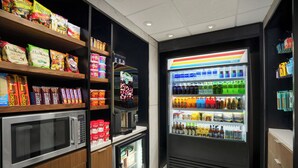 A self-service snack and beverage kiosk with a microwave, refrigerated section, and a variety of snacks and drinks. - Courtyard by Marriott Chicago Midway Airport (Chicago)
