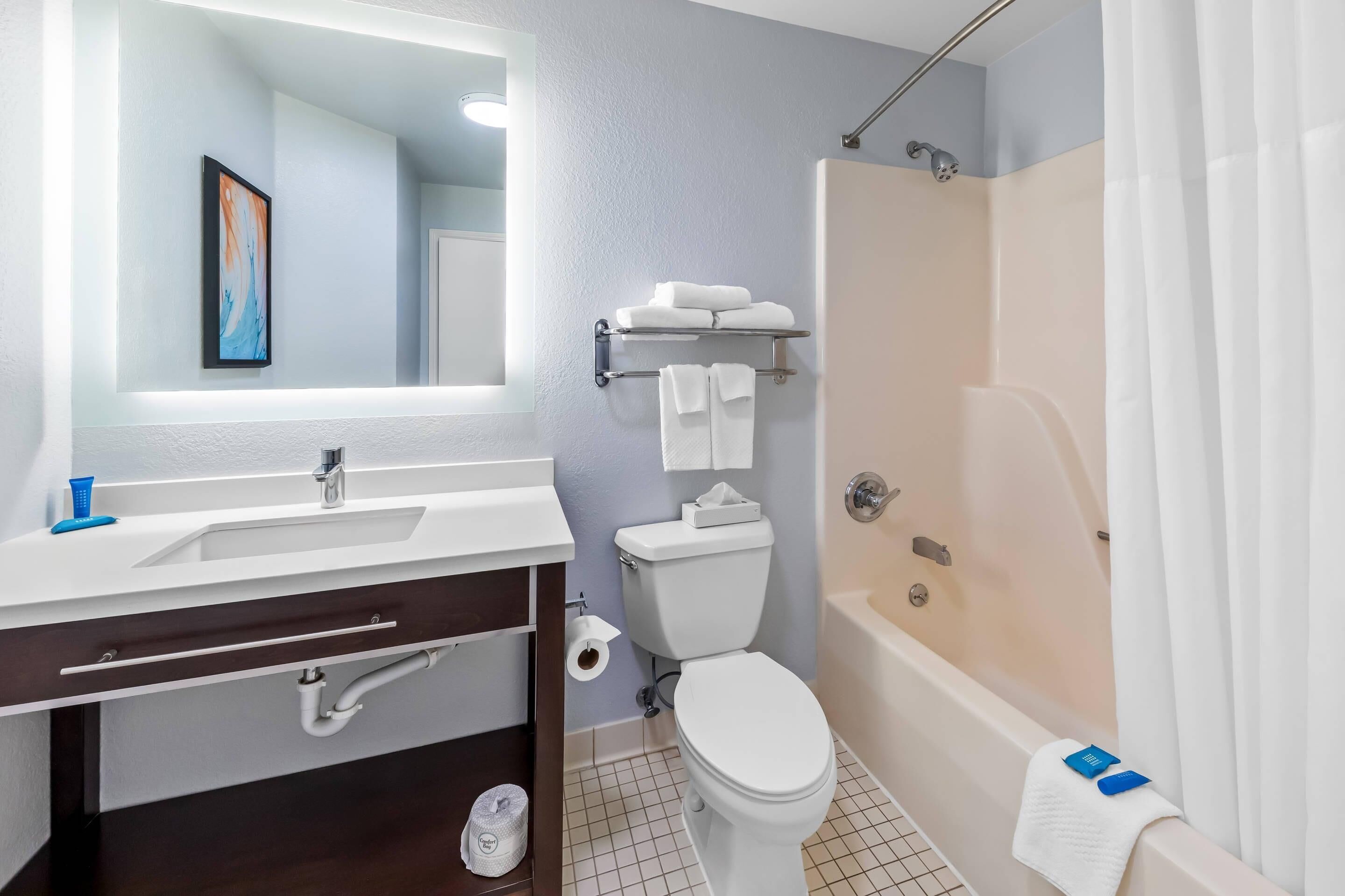 A bathroom with a sink, toilet, and bathtub.