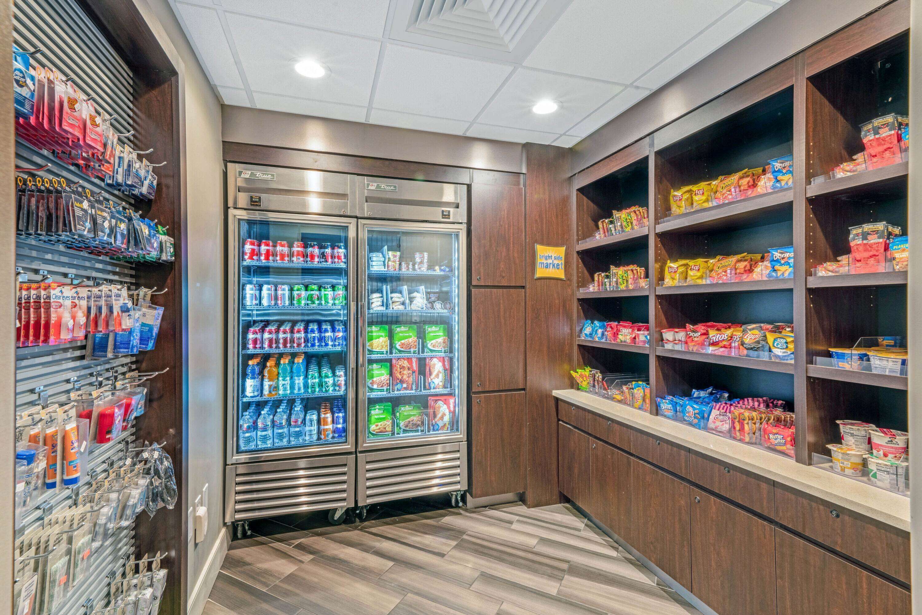 A grocery store with refrigerated sections, shelves stocked with snacks, and a variety of packaged goods.
