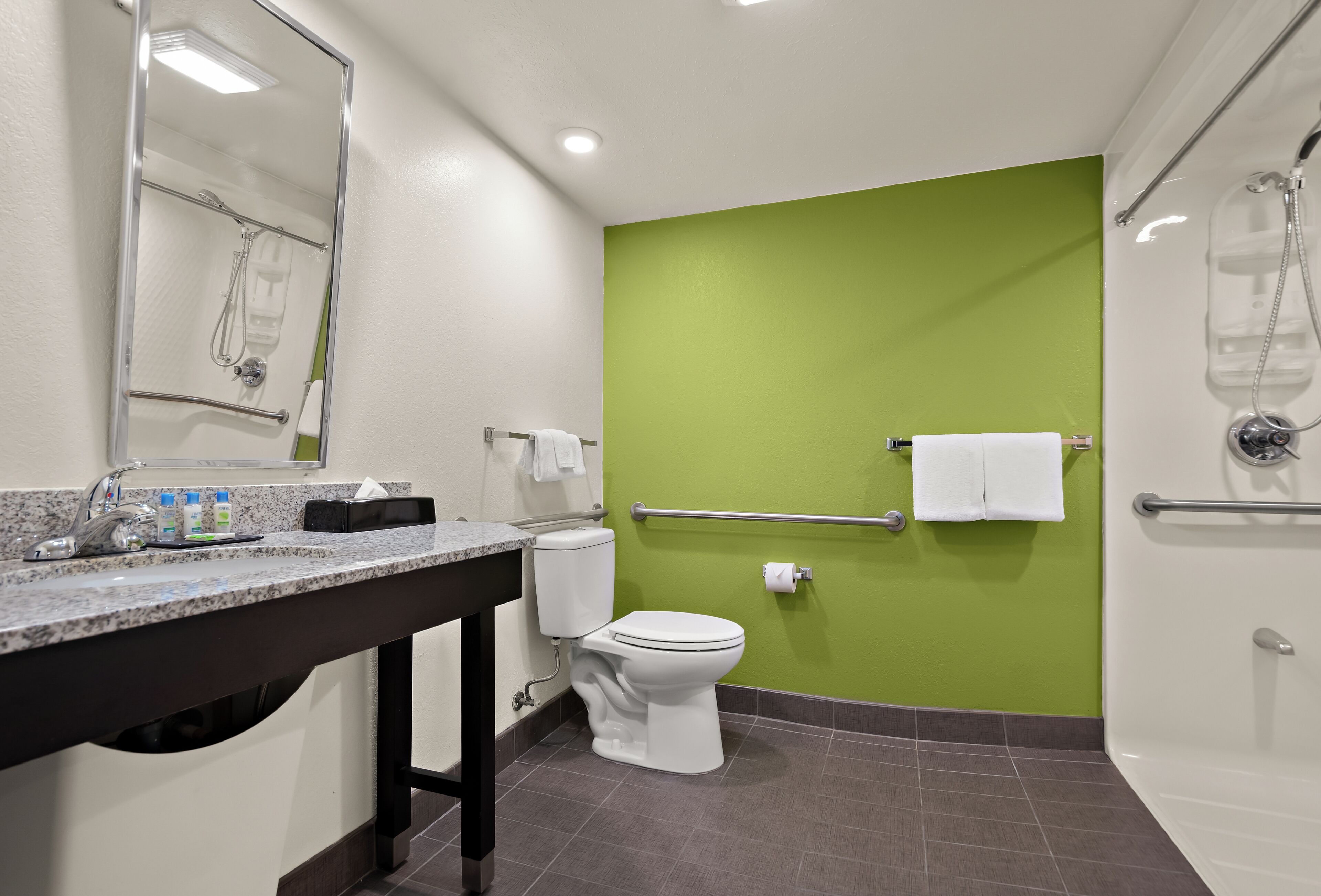 A bathroom with a toilet, sink, and shower.