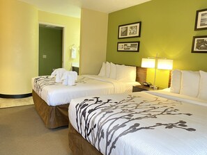 Premium bedding, desk, laptop workspace, blackout drapes