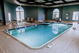 Una piscina techada, sillones reclinables de piscina