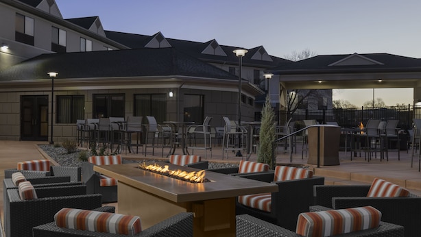 An outdoor patio area with a fire feature, seating, and a covered section. - Holiday Inn Express & Suites Montrose - Black Canyon Area by IHG (Montrose)