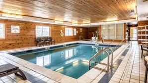 An indoor swimming pool with wooden walls, a tiled floor, and a sign indicating no diving is allowed. - Comfort Inn & Suites - Hannibal (Hannibal)
