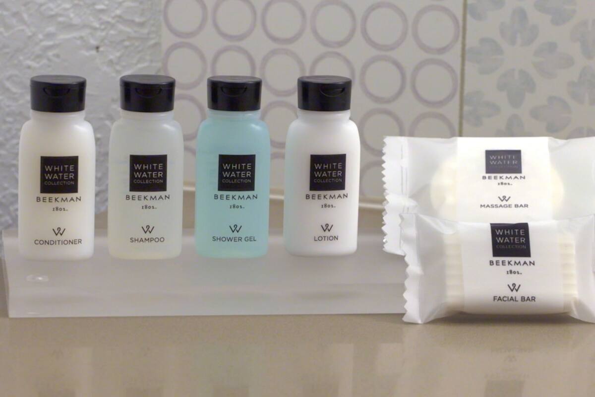 A display of White Water Collection products including conditioner, shampoo, shower gel, and lotion, along with a facial bar.