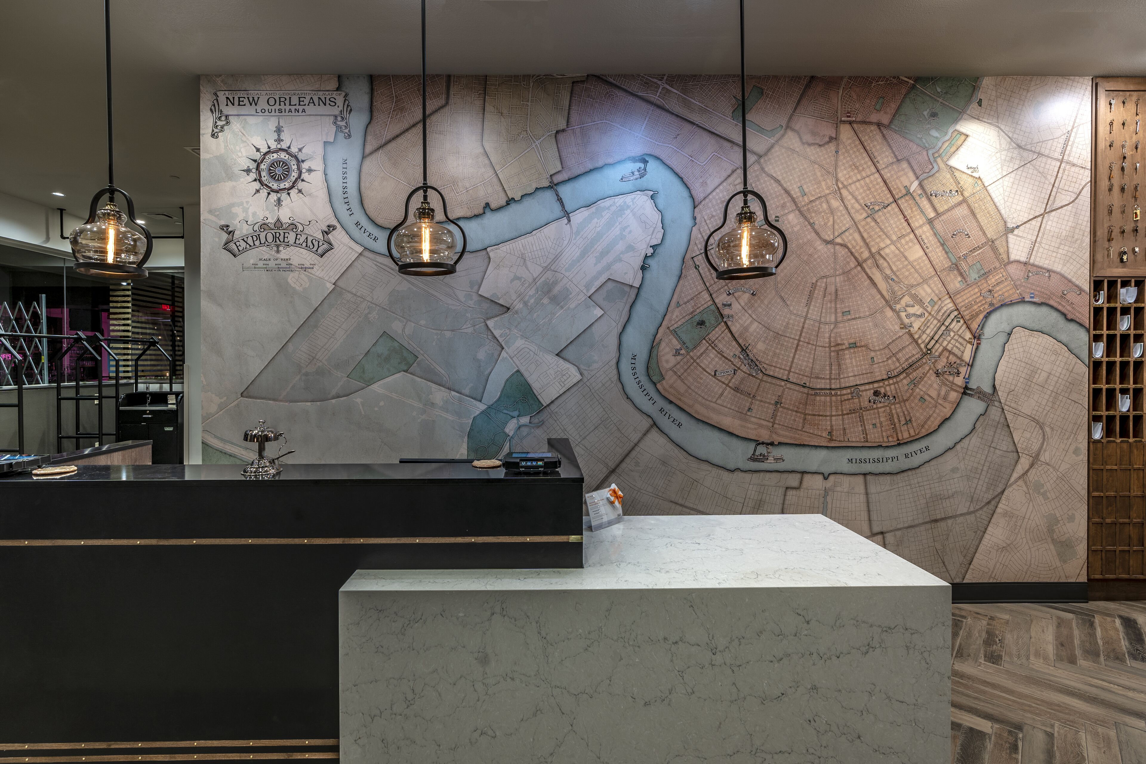 A reception desk with a large map of New Orleans, Louisiana, and a wooden panel with a grid pattern.