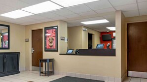 A reception area with a reception desk, a computer, a telephone, and a television mounted on the wall. - Extended Stay America Suites Detroit Madison Heights (Madison Heights)