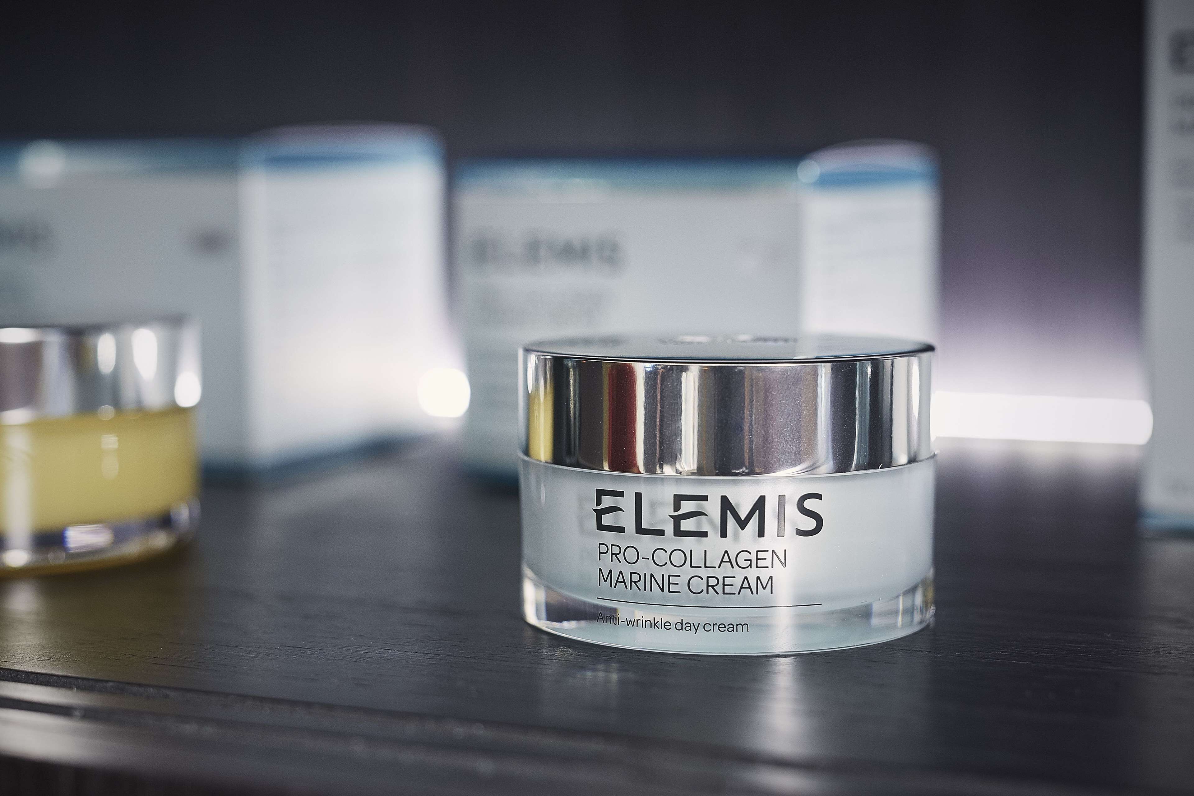 A container of Elemis Pro-Collagen Marine Cream on a dark surface.