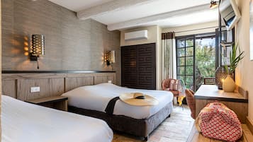 Triple Room (Cavalière) | Minibar, in-room safe, individually decorated, individually furnished