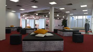 A modern lounge area with modular seating and a red carpet.