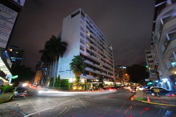 A multi-story hotel with a modern design, featuring balconies and a prominent entrance.