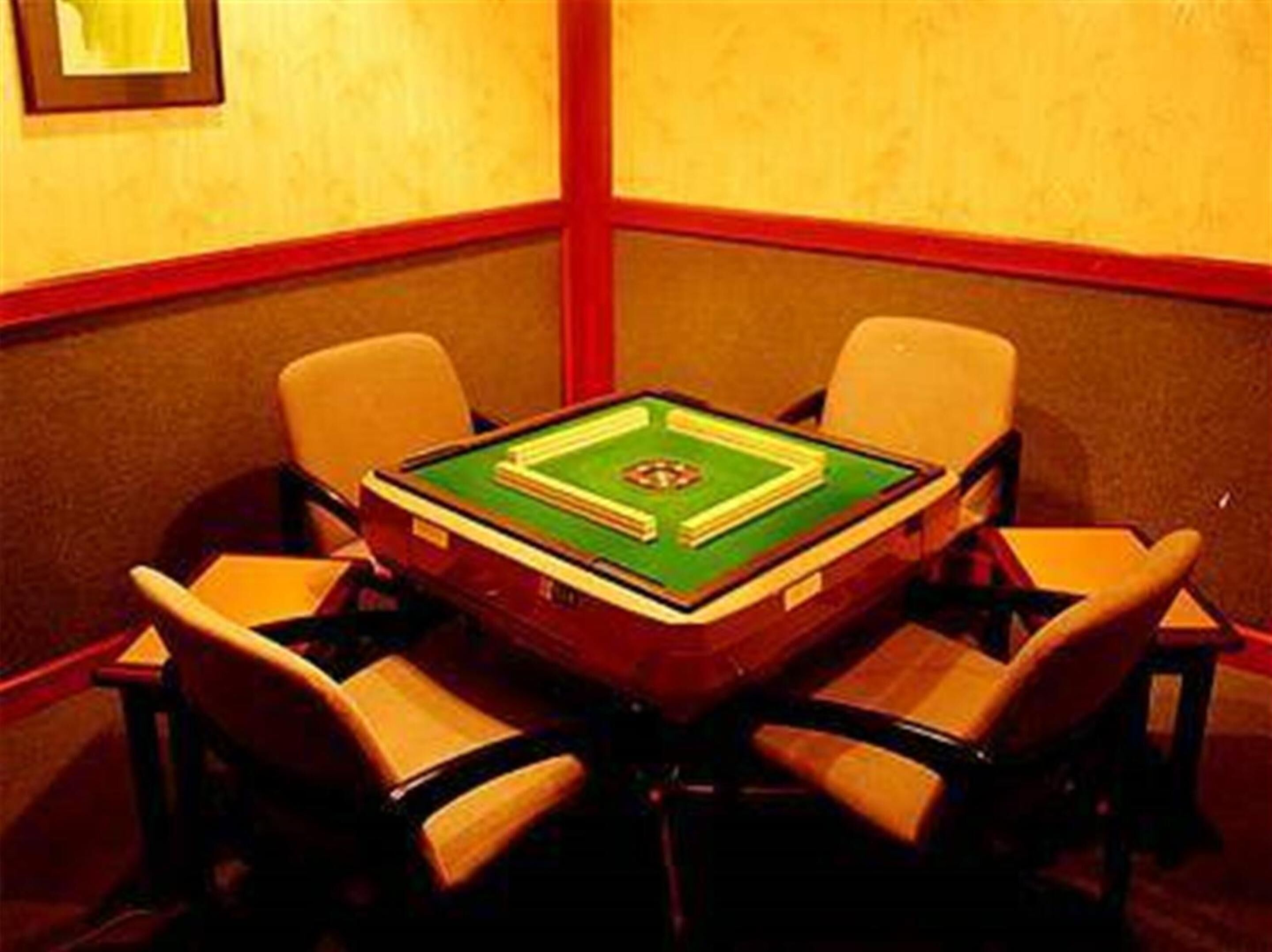 A room with a pool table, four chairs, and a framed picture on the wall.