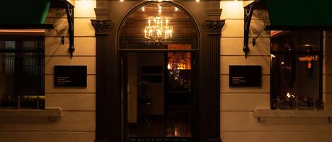 El exterior del hotel 'The Address', con una entrada imponente, una araña de cristal y un cartel sobre la puerta.