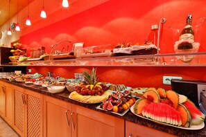 A buffet with various fruits, vegetables, and desserts. - Hotel Wallis by ANS (Munich)