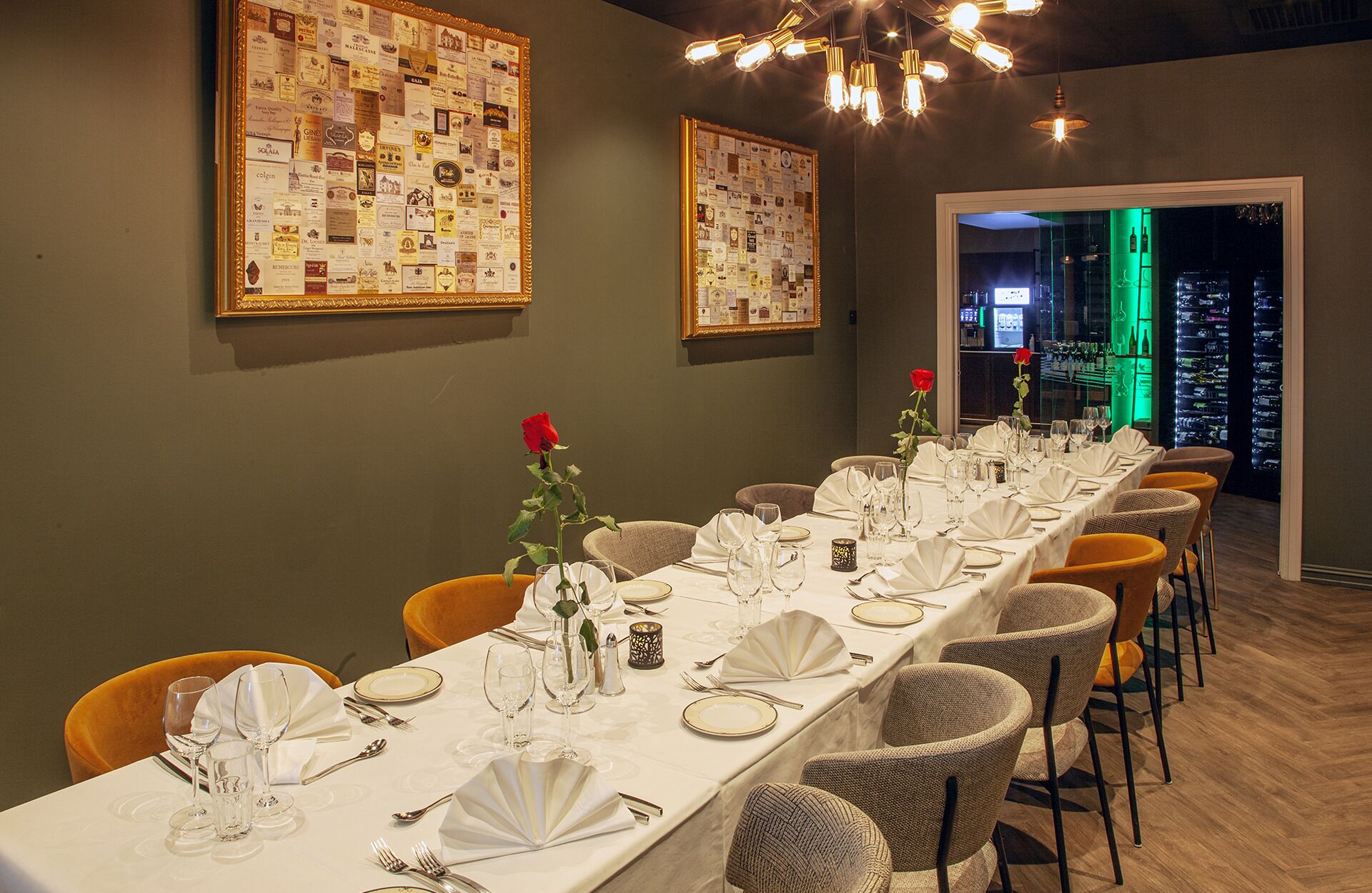 A long dining table set for a meal, with chairs on both sides.
