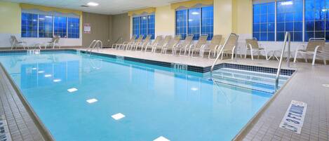 A swimming pool with clear water, tiled edges, and multiple lanes.