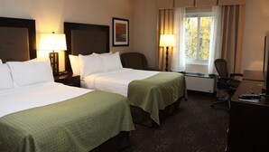 A hotel room with two beds, a desk, a chair, and a window with curtains. - Holiday Inn Budd Lake - Rockaway Area by IHG (Budd Lake)