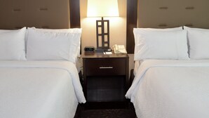 A hotel room with two beds, a nightstand with a lamp, a phone, and a digital clock. - Holiday Inn Budd Lake - Rockaway Area by IHG (Budd Lake)