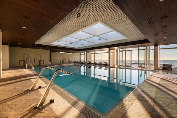 Indoor pool, pool umbrellas, pool loungers
