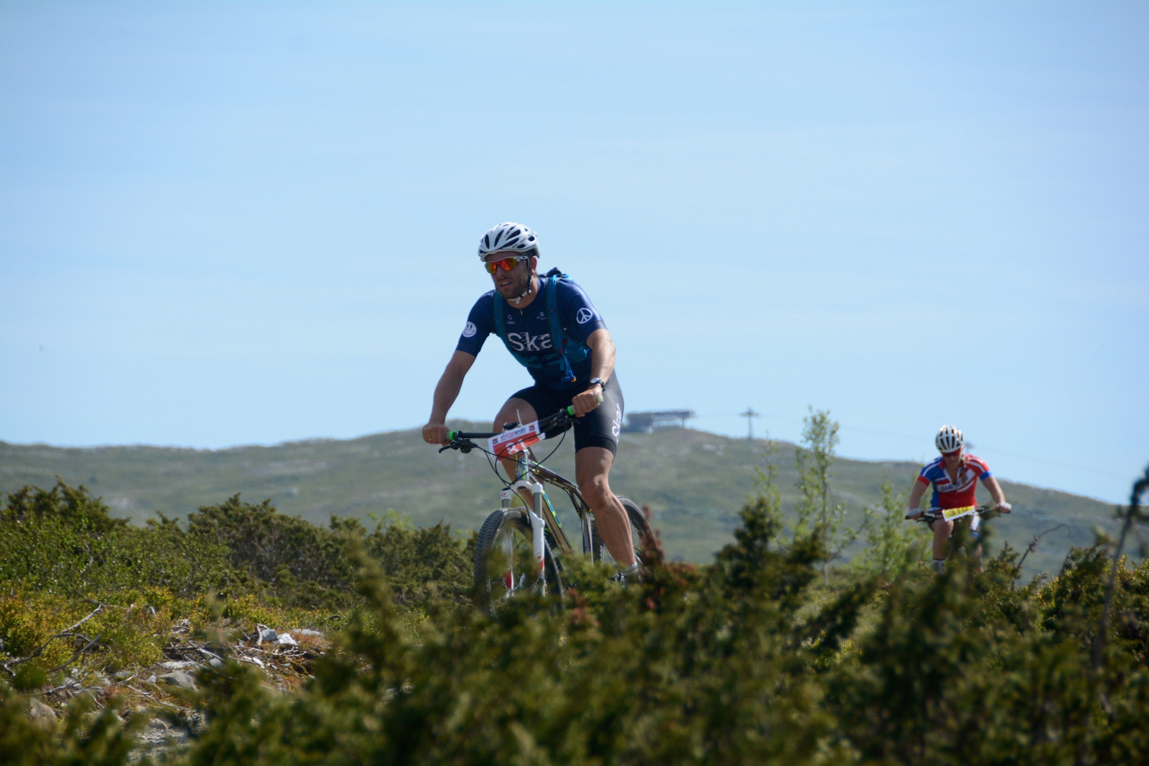 A cyclist riding on a mountain trail.