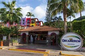 A colorful building with a sign reading "Decameron Los Cocos."