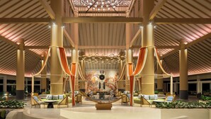 A spacious lobby with high ceilings, large pillars, and a central seating area with sofas and chairs. - Mövenpick Resort & Spa Bintan Lagoon (Bintan)