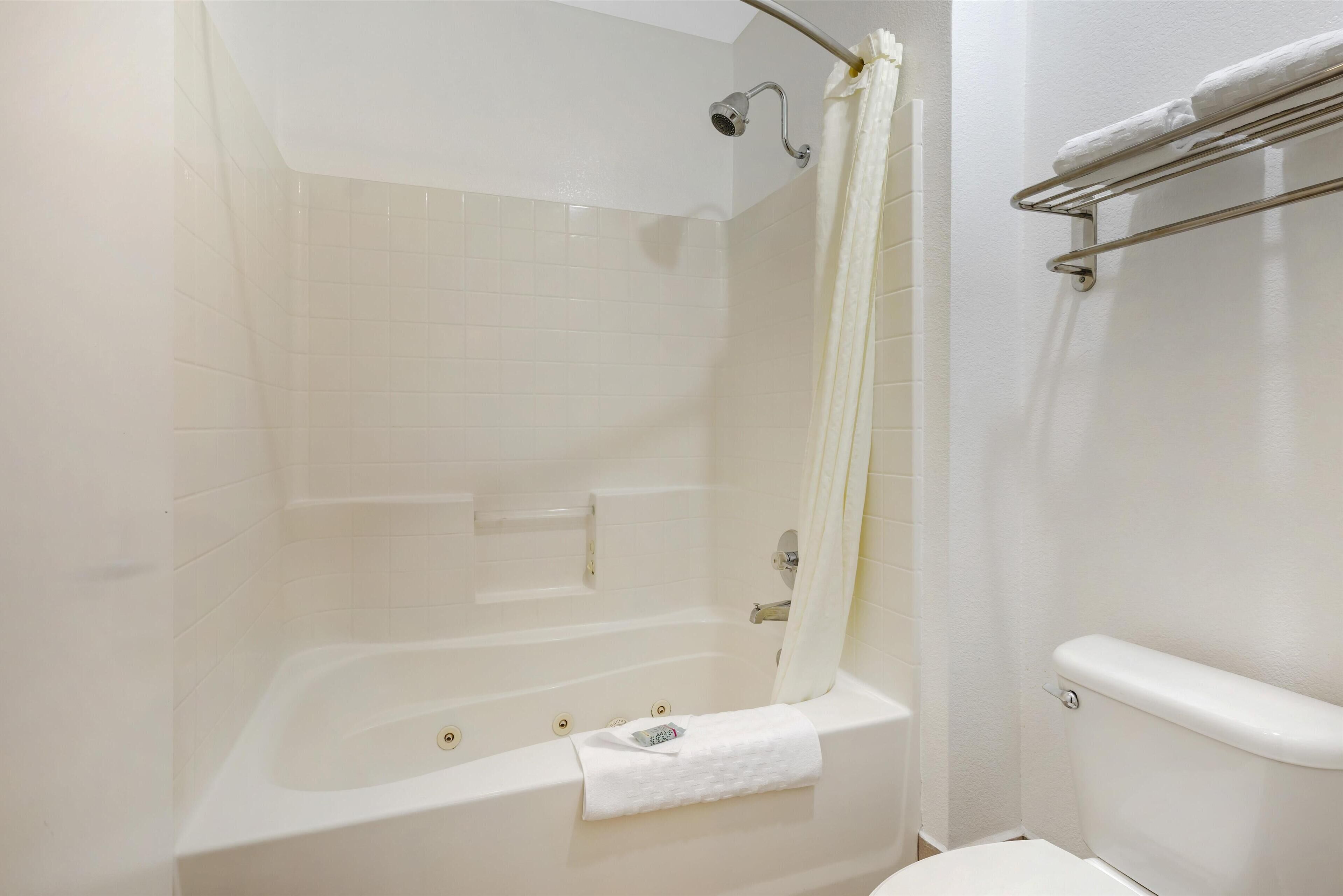 suite, 1 king bed, non smoking, refrigerator & microwave (larger room;with sofabed) | bathroom | free toiletries, hair dryer, towels, soap