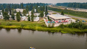 A lakeside building with a dock and a kayak in the water. - Rivers Edge Resort (Fairbanks)