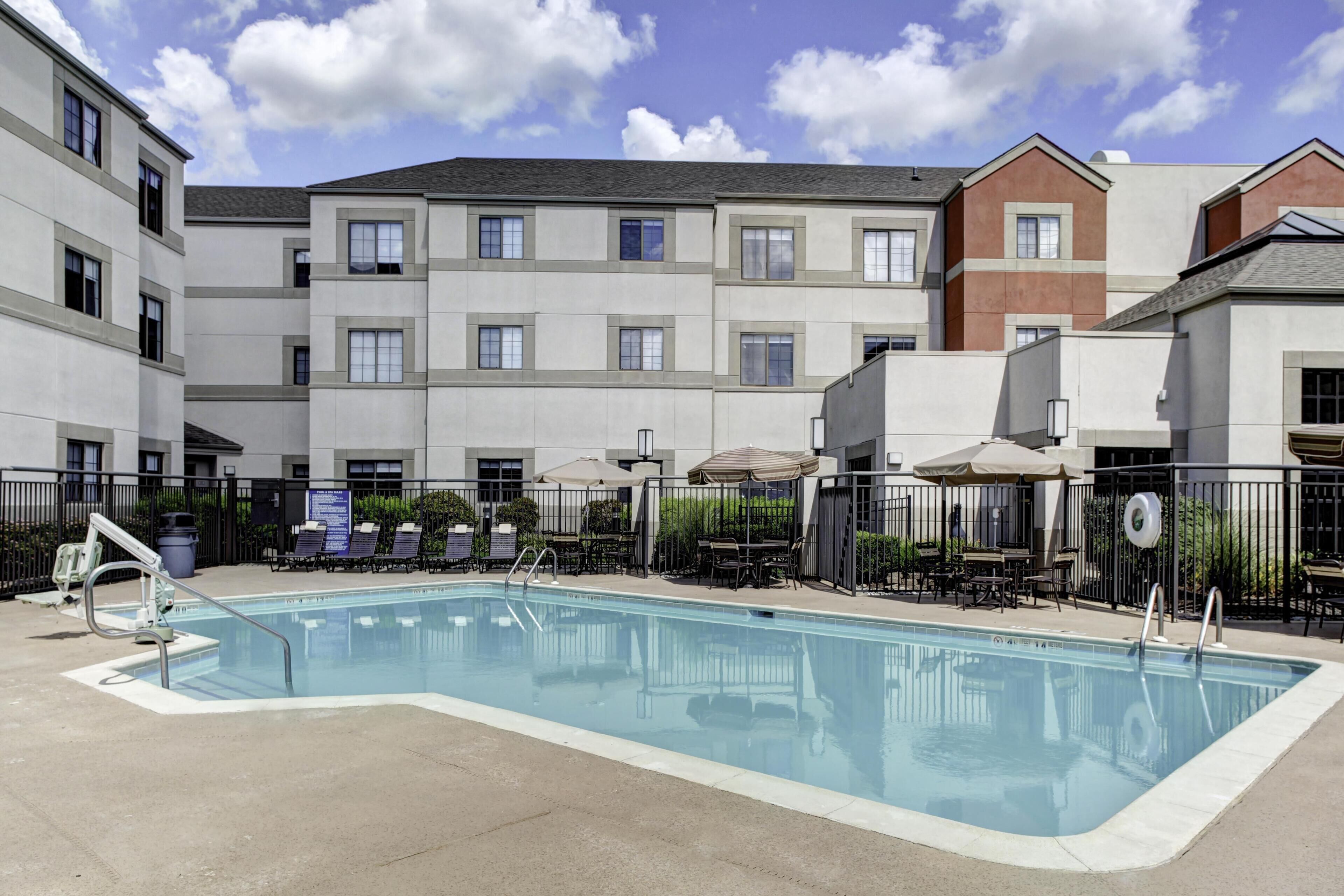 Seasonal outdoor pool, open 10:00 AM to 10:00 PM, pool umbrellas