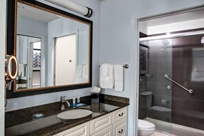 A bathroom with a sink, mirror, and shower. - HYATT House Morristown (Morristown)