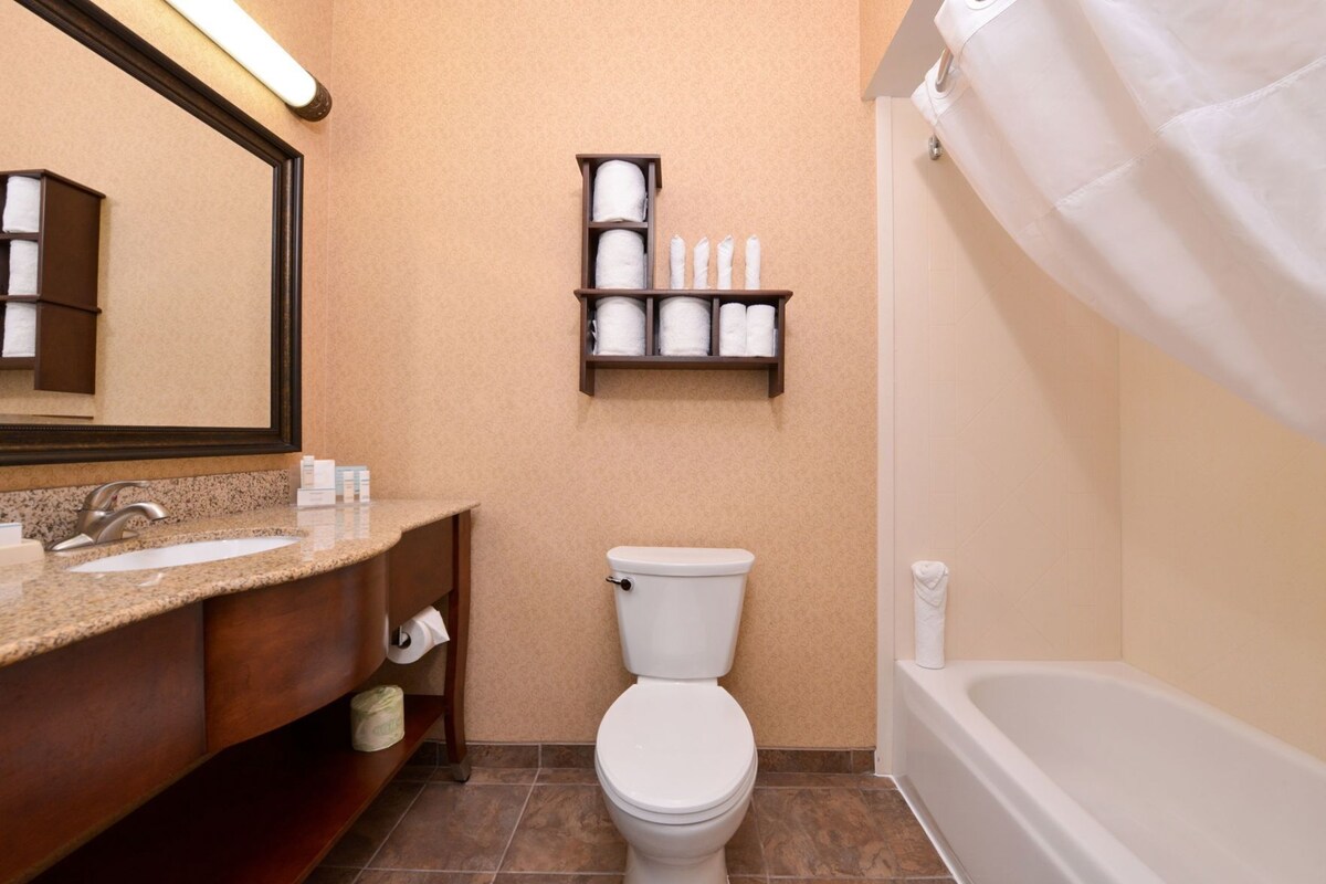 A bathroom with a sink, toilet, and bathtub.