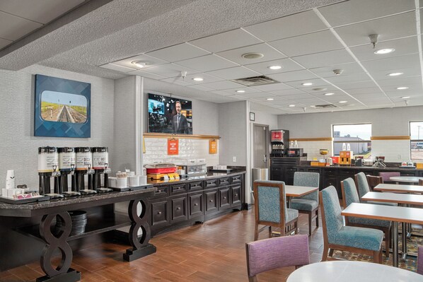 Relax in our inviting lobby, featuring a central coffee station and comfortable seating areas.