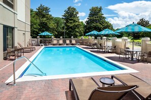 Seasonal outdoor pool, open 10:00 AM to 10:00 PM, pool umbrellas