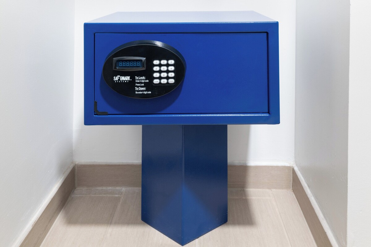 A blue safe with a digital keypad and instructions for locking and unlocking.
