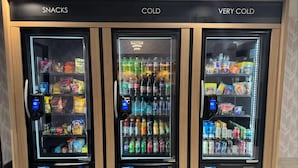 Three beverage vending machines labeled "SNACKS," "COLD," and "VERY COLD." - Days Inn & Suites by Wyndham Wausau (Wausau)