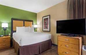 A hotel room with a bed, two bedside tables, a television, and a framed picture on the wall. - Extended Stay America Suites Phoenix Scottsdale (Scottsdale)