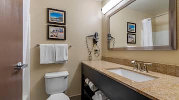A bathroom with a toilet, sink, and towel rack.