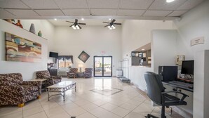 A spacious lobby with a sofa, chairs, a coffee table, and a computer desk. - Quality Inn O'Fallon - St. Louis - Shiloh (O'Fallon)