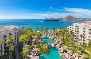Enjoy breathtaking ocean views from the comfort of your balcony or relax by the pool surrounded by palm trees.