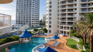 A hotel with a pool area, multiple balconies, and a view of the ocean. - BreakFree Moroccan (Surfers Paradise)