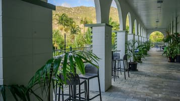 Relax in a serene outdoor space surrounded by lush greenery and breathtaking mountain views.