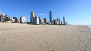 A beach with a city skyline in the background.