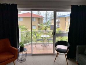 Enjoy the view from your balcony with a sliding glass door, featuring a small table and two chairs.