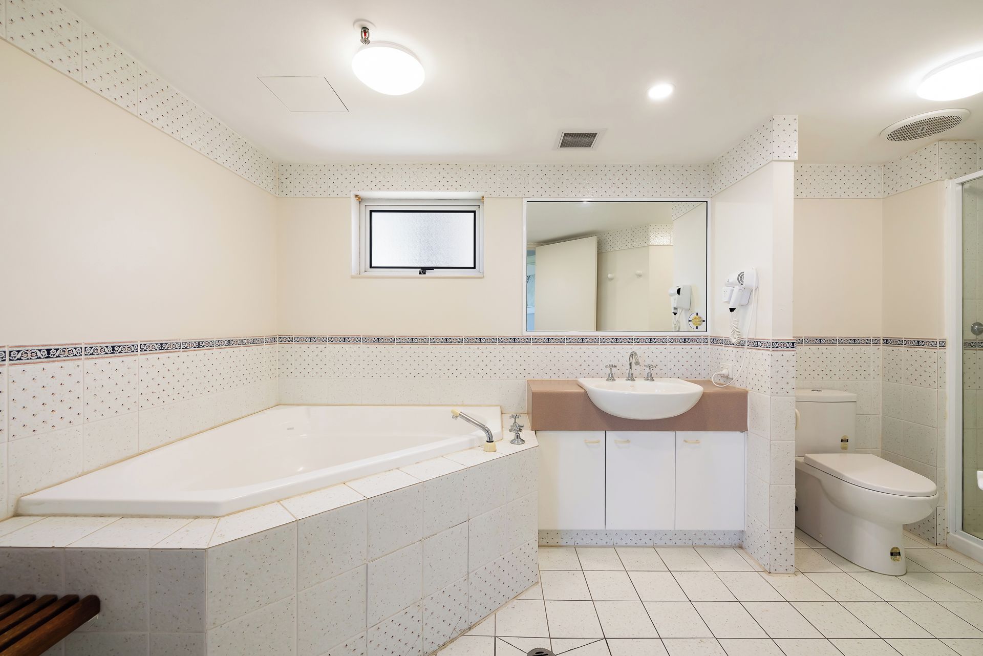A bathroom with a bathtub, sink, and toilet.