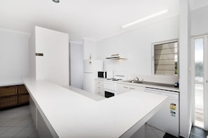 Standard Apartment, 3 Bedrooms, Garden Area | Private kitchen | Full-size fridge, microwave, stovetop, cookware/dishes/utensils