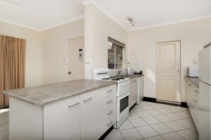 Full-sized fridge, microwave, stovetop, electric kettle