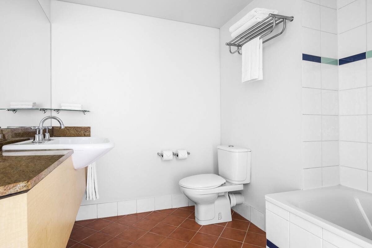 A bathroom with a sink, toilet, and bathtub.