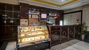 A bakery counter with a glass display case filled with pastries and desserts.