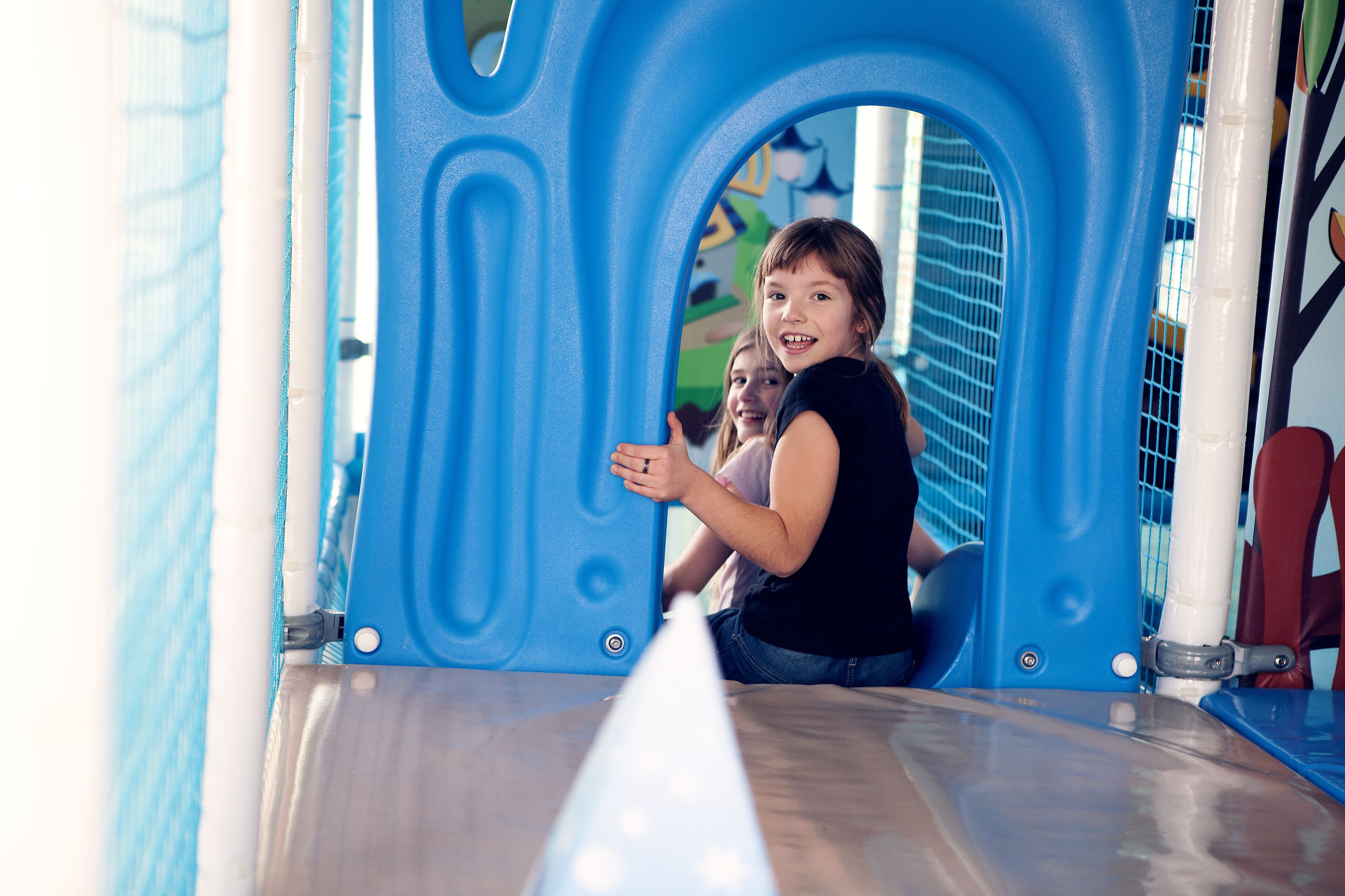 A play structure with a blue archway and a slide.