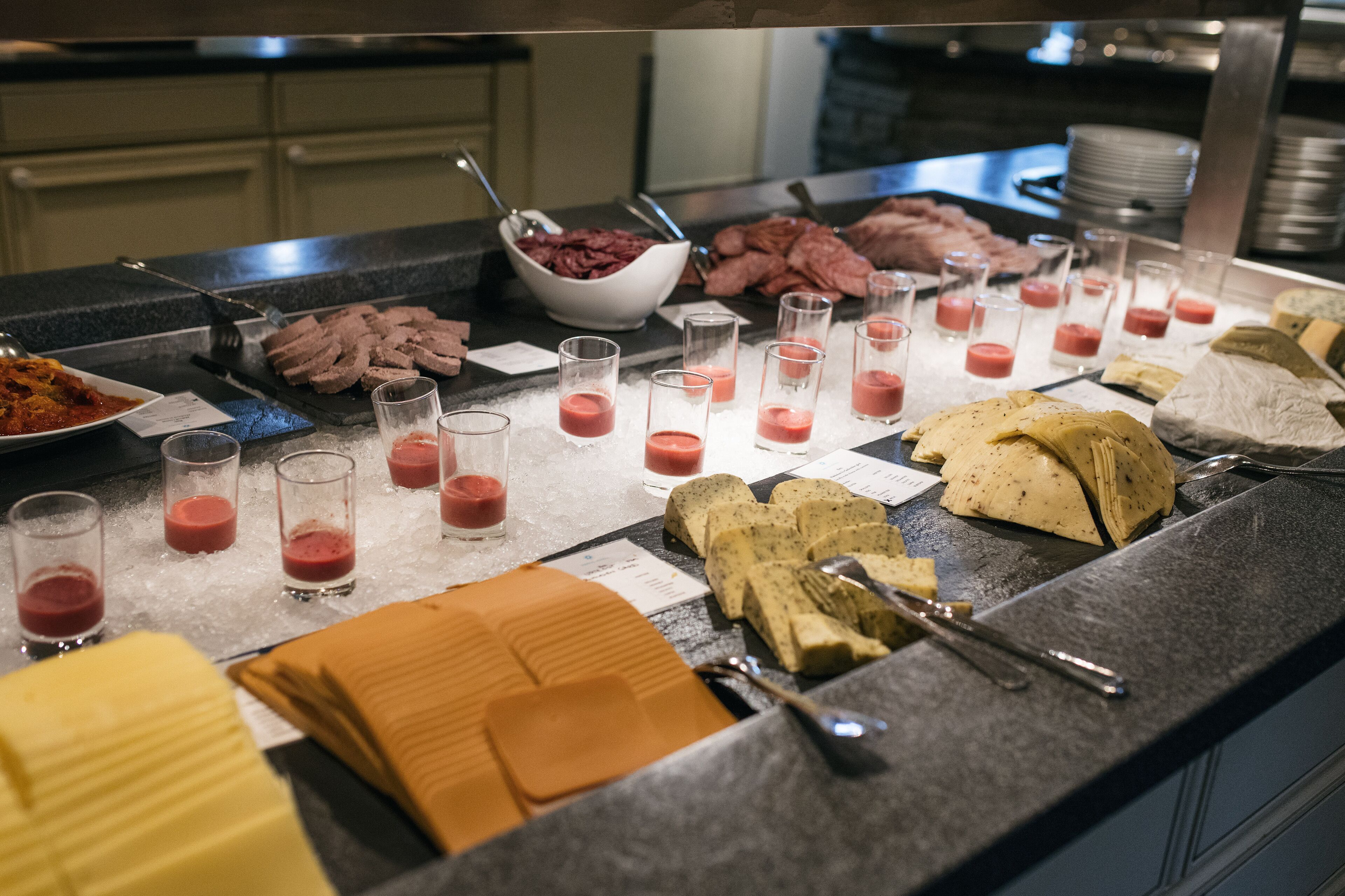 A buffet with various food items and beverages.